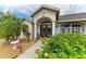 Charming front entrance of home featuring double doors, a portico, well-maintained landscaping, and clearly marked address at 15375 Taurus Cir, Port Charlotte, FL 33981