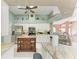 Open kitchen featuring an island, white cabinets, and modern appliances at 15375 Taurus Cir, Port Charlotte, FL 33981