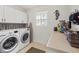 Well-lit laundry room with washer, dryer, and ample counter space at 15375 Taurus Cir, Port Charlotte, FL 33981