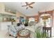 Spacious living room with a high ceiling, comfortable seating, a TV, and a view into the kitchen area at 15375 Taurus Cir, Port Charlotte, FL 33981