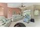 Open-concept living room with vaulted ceilings, plush sofas, and sliding glass doors to the pool area at 15375 Taurus Cir, Port Charlotte, FL 33981