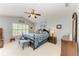 Main bedroom features a ceiling fan, carpet flooring, and a window with shutter blinds at 15375 Taurus Cir, Port Charlotte, FL 33981