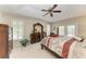 Well-lit main bedroom with tray ceiling, a king bed, and private backyard access at 15375 Taurus Cir, Port Charlotte, FL 33981