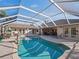 Inviting screened pool area with lounge chairs and fountain at 15375 Taurus Cir, Port Charlotte, FL 33981