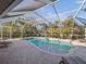 Spacious pool area with covered lanai and lounge chairs at 15375 Taurus Cir, Port Charlotte, FL 33981