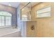 Bathroom featuring a tiled shower with glass partition and a window for natural light at 15375 Taurus Cir, Port Charlotte, FL 33981