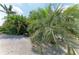 Lush landscaping and tropical plants create a serene outdoor space around the home at 15375 Taurus Cir, Port Charlotte, FL 33981