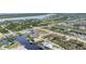 Aerial view of canal-front homes in a coastal community near tranquil blue waters at 15500 Longview Rd, Port Charlotte, FL 33981