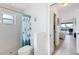 Bright bathroom with a shower and view into the adjacent bedroom with a sliding door to the patio at 15500 Longview Rd, Port Charlotte, FL 33981