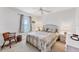 Bright bedroom features a ceiling fan and a comfortable bed with a floral pattern comforter at 15500 Longview Rd, Port Charlotte, FL 33981