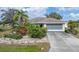 Single-story home with a screened garage and nicely landscaped yard at 15500 Longview Rd, Port Charlotte, FL 33981