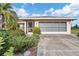 Single story home with a screened garage and neatly landscaped yard at 15500 Longview Rd, Port Charlotte, FL 33981