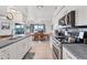 Eat-in kitchen with stainless steel appliances and view to dining area at 15500 Longview Rd, Port Charlotte, FL 33981