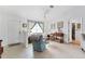 Bright living room with tiled floors, comfy seating, and lots of natural light at 15500 Longview Rd, Port Charlotte, FL 33981
