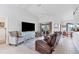 Bright living room with vaulted ceiling, comfy seating, and tile floors at 15500 Longview Rd, Port Charlotte, FL 33981