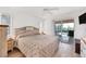 Main bedroom with king-size bed and sliding doors to pool area at 15500 Longview Rd, Port Charlotte, FL 33981