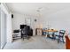 Home office with desk, chair, and view to living room at 15500 Longview Rd, Port Charlotte, FL 33981