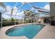 Inviting screened pool area with patio and canal view at 15500 Longview Rd, Port Charlotte, FL 33981