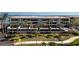Aerial view of waterfront condo building with lush landscaping and water access at 1651 Beach Rd # 212, Englewood, FL 34223