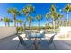 Relaxing balcony with table and chairs, overlooking lush tropical landscape at 1651 Beach Rd # 212, Englewood, FL 34223