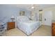 Bright bedroom with double bed, nightstands, and ceiling fan at 1651 Beach Rd # 212, Englewood, FL 34223