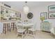 Charming dining area with white table and chairs, adjacent to kitchen at 1651 Beach Rd # 212, Englewood, FL 34223