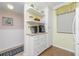 Kitchen features white cabinets, built-in shelving, and coffee bar at 1651 Beach Rd # 212, Englewood, FL 34223