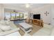Living room features comfortable seating and a large TV at 1651 Beach Rd # 212, Englewood, FL 34223