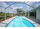 Inviting kidney-shaped pool with screened enclosure at 17412 Wintergarden Ave, Port Charlotte, FL 33948