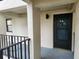 Condo entrance with a dark brown door and a small balcony at 1751 Beach Rd # 204, Englewood, FL 34223