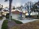 Community patio with picnic tables and umbrellas at 1751 Beach Rd # 204, Englewood, FL 34223
