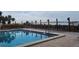 Community pool with lounge chairs and waterfront views at 1751 Beach Rd # 204, Englewood, FL 34223