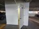 Unit #204 storage unit with door ajar located on a parking garage level for ease of access at 1751 Beach Rd # 204, Englewood, FL 34223