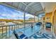 Covered balcony overlooking the water, with seating for relaxing and enjoying the view at 1954 Oregon Trl # 2G, Englewood, FL 34224