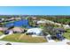 Aerial view showing a single-Gathering home near a lake in a residential area at 2271 Paraiso Ct, Englewood, FL 34224