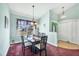 Dining room with a dark wood table, six chairs, and a light and airy feel at 2271 Paraiso Ct, Englewood, FL 34224