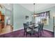 Dining area with a dark wood table and six chairs, adjacent to kitchen at 2271 Paraiso Ct, Englewood, FL 34224