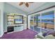 Gathering room with a large TV, plenty of storage, and sliding doors to patio at 2271 Paraiso Ct, Englewood, FL 34224