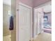 Hallway with tile floor and doors to bedrooms at 2271 Paraiso Ct, Englewood, FL 34224