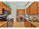 Kitchen features granite countertops, wood cabinets, and built-in desk at 2271 Paraiso Ct, Englewood, FL 34224