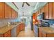 Kitchen with granite countertops, wood cabinets, and stainless steel appliances at 2271 Paraiso Ct, Englewood, FL 34224