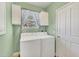Laundry room with washer, dryer, and cabinets at 2271 Paraiso Ct, Englewood, FL 34224