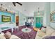 Living room features a neutral color palette, comfy seating, and a glass coffee table at 2271 Paraiso Ct, Englewood, FL 34224