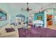 Spacious living room with a white piano, comfy couch, and large windows at 2271 Paraiso Ct, Englewood, FL 34224