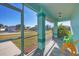 Bright and airy screened porch with seating at 2271 Paraiso Ct, Englewood, FL 34224