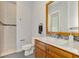 Modern bathroom with shower, toilet and wood vanity at 3111 Rivershore Ln, Port Charlotte, FL 33953