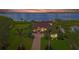 Waterfront property at dusk showcasing a luxurious home with a tile roof at 3111 Rivershore Ln, Port Charlotte, FL 33953