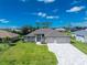 Aerial view of single Gathering home with driveway and landscaping at 35 Broadmoor Ln, Rotonda West, FL 33947