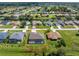 Bird's-eye view of a house with a pool, showcasing its location in a residential neighborhood at 35 Broadmoor Ln, Rotonda West, FL 33947