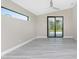 Spacious bedroom with gray vinyl plank flooring and sliding glass doors at 35 Broadmoor Ln, Rotonda West, FL 33947